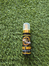 Load image into Gallery viewer, KUSHFADES 5 ounce peppermint face wash bottle on green turf